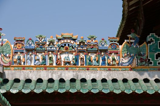 The carving of figurines on roof of Chinese temple
