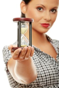 Young business woman with hourglass - time concept . Isolated on white background