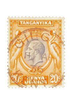 Kenya, Uganda & Tanganyika - Circa 1935 : A vintage British Colony postage stamp image of a pair of exotic birds either side of a portrait of King George and a value of 20 cents, series circa 1935