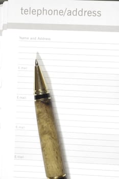 pen resting on a telephone/address book ready to use