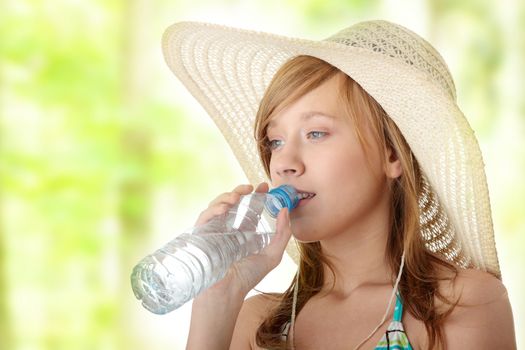 Summer girl with bottle of mineral water