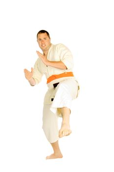 young man doing martial art exercises isolated on a white background