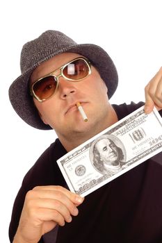 young man in a hat and sunglasses holding a fake large 100 dollar bill, isolated on white