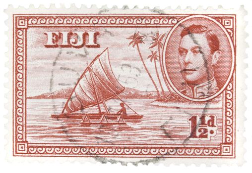 Fiji - Circa 1950 : A vintage Fijian postage stamp image of a native catamaran with inset of King George and a face value of 1 1/2 pence, series circa 1940