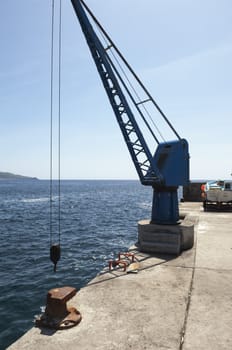 Port crane in a small harbor, Pico, Azores