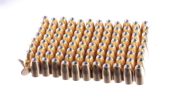 9mm bullets lined up in rows, isolated on white