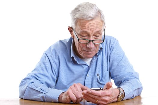 Senior man pulling a face while holding a mobile