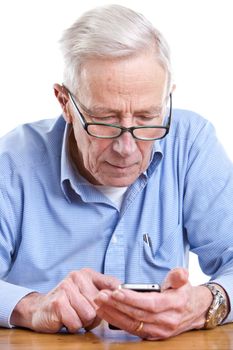 Senior man trying to figure out his mobile phone