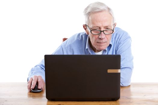Senior man behind his computer looking interested on white background