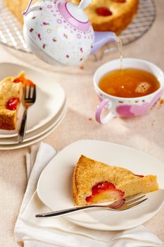 Slice of plum pie with a cup of tea