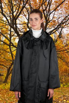 woman in rain coat walking at autumn forest