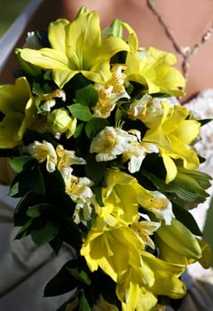 The bride holds a wedding bouquet
