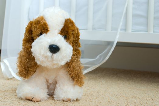 Lovely puppy-toy near child's bed
