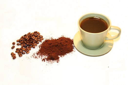 gelbe Kaffeetasse mit Bohnen und Pulver	
yellow coffee cup with beans and powder