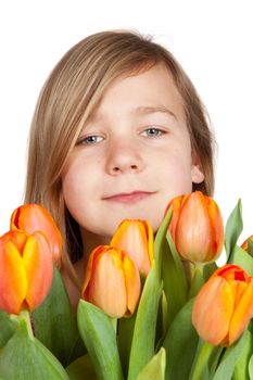 cute young girl is holding a bunch of tulips