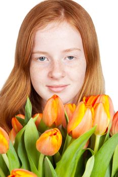 cute young girl is holding a bunch of tulips