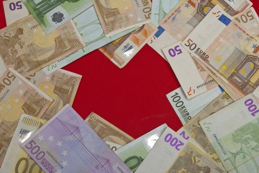 Euro bills on red background,recorded above them.