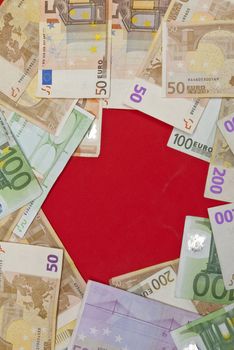 Euro bills on red background,recorded above them.