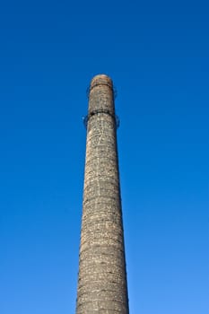 Old chimney-stalk on a background blue sky