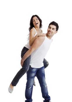 Beautiful and happy young couple standing over a white background