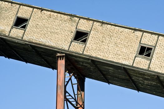 close shot of abandoned factory building and small metal chimneys