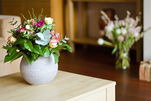 Part of modern interior with two bouquets of flowers -  shallow dof