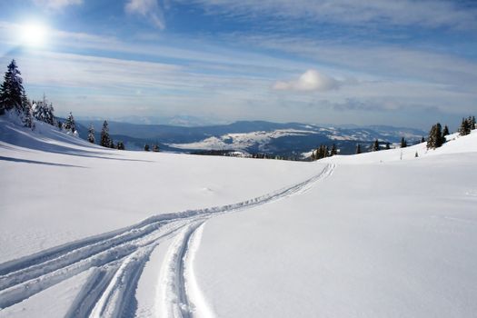 snowy mountain panorama with snow trails