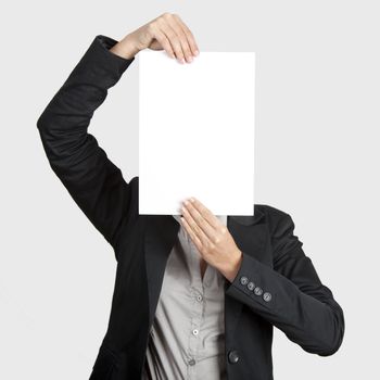 Woman showing a blank paper sheet in front of her head
