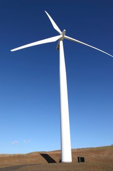 Turbine blades and generators creating power with the wind.