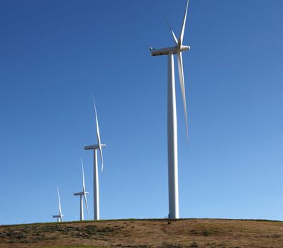 Turbine blades and generators creating power with the wind.