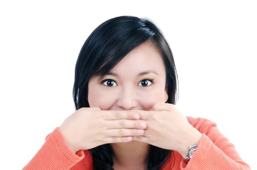 Portrait of beautiful young woman covering her mouth with both hands over white background