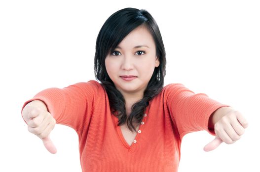 Portrait of a beautiful woman showing thumbs down sign over white background.