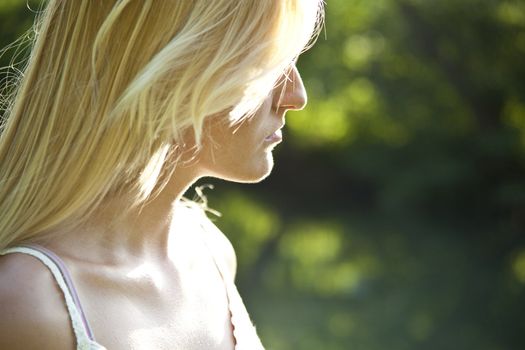 Beautiful woman resting on river, green environment