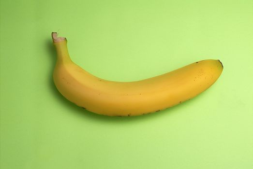 One Bannana on green background - good for eat