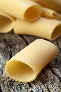 close up of Italian raw pasta on wood
