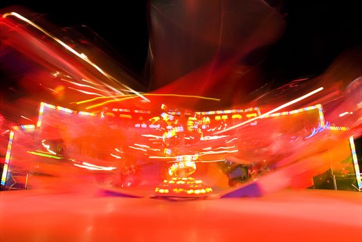 Blur neon lights in amusement park, long exposure