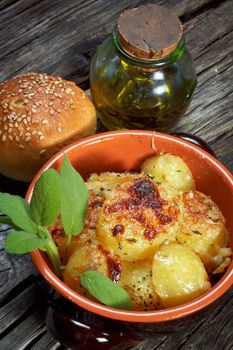 baked potatoes au gratin on a earthen bowl