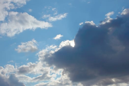 Beautiful autumn cloudscape, dark grey and white clouds on the blue sky