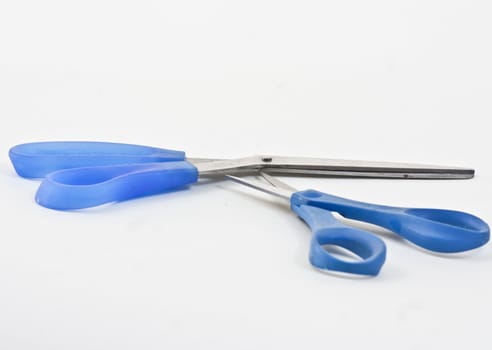 Two pairs of different size scissors on a white background.