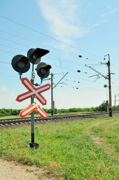 Traffic lights at a railway crossing and railroad.