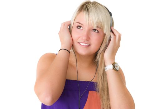 Young beautiful girl standing and listening to music on here headphones. Over white background