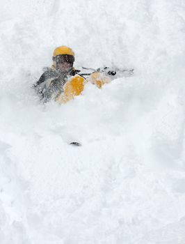 Skier falling over in deep snow