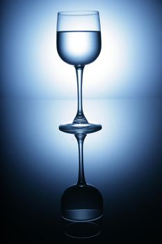 water glass on reflecting ground shimmering blue