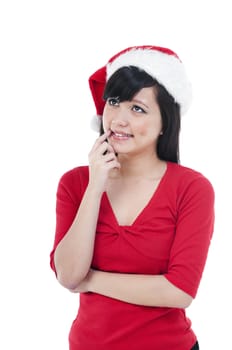 Portrait of a cute Christmas woman thinking and looking upwards against white background.