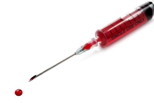 Syringe filled with blood on white