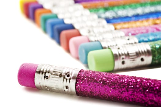 Colorful pencils with erasers covered in glitter