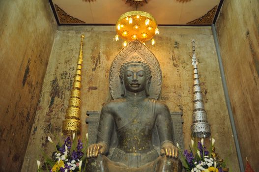 statue of old buddha at thailand temple
