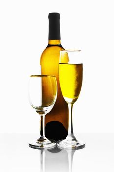 Bottles and glasses of wine on white background