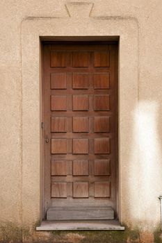 Old wooden door in stucco building