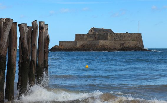 Image of The Fort National from Saint Malo,in Brittany in northwestern France, during the high tide time.The construction was used first as a reference point for the ships and from 1869 became a defensive bastion against the English attacks.